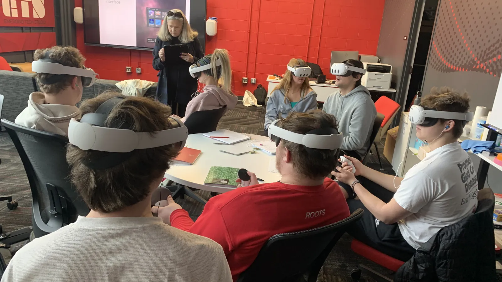 Rebecca Bias and students engage in a VR activity