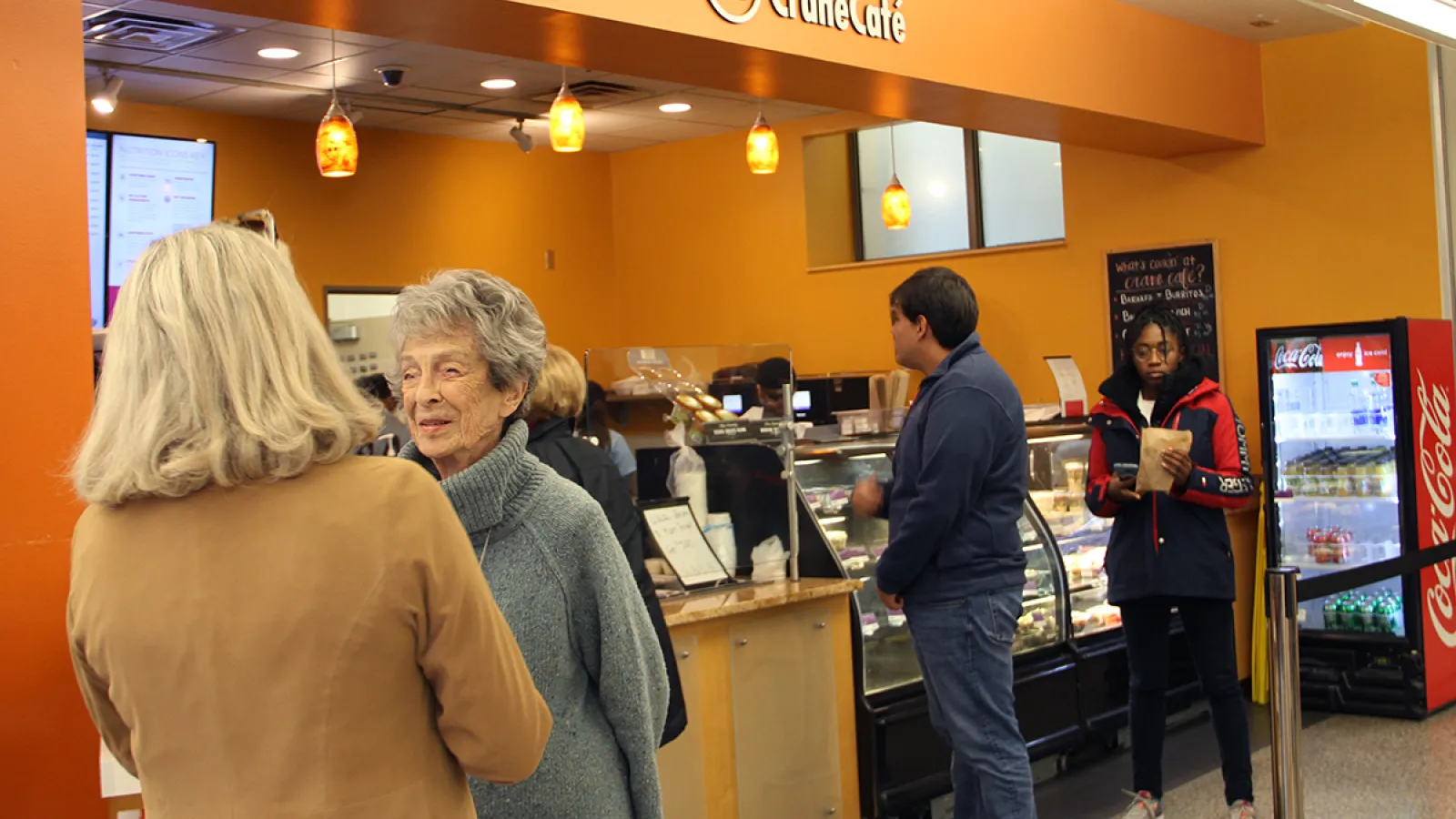Loann Crane talks to CLLC Assistant Director during a visit to Hagerty Hall.