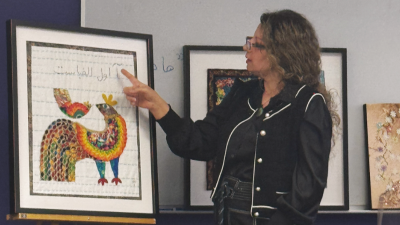 Parvaneh Hosseini displays her textiles for a presentation.