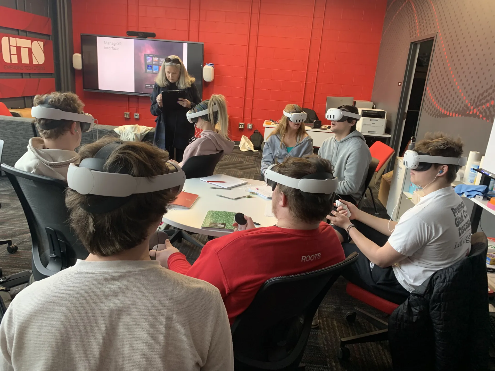 Rebecca Bias and students engage in a VR activity
