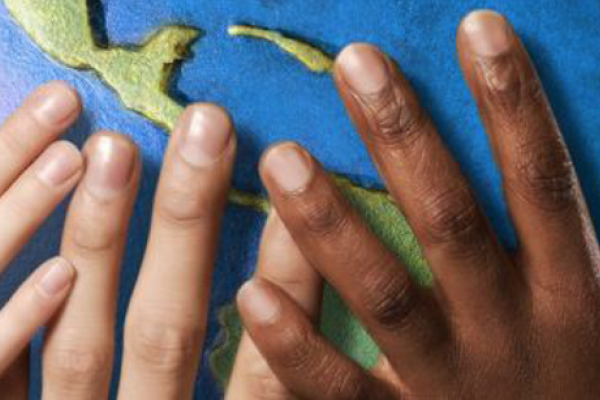 Globe with diverse hands holding it
