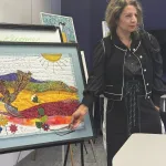 Parvaneh Hosseini displays her textiles for a presentation.