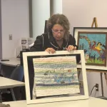 Parvaneh Hosseini displays her textiles for a presentation.